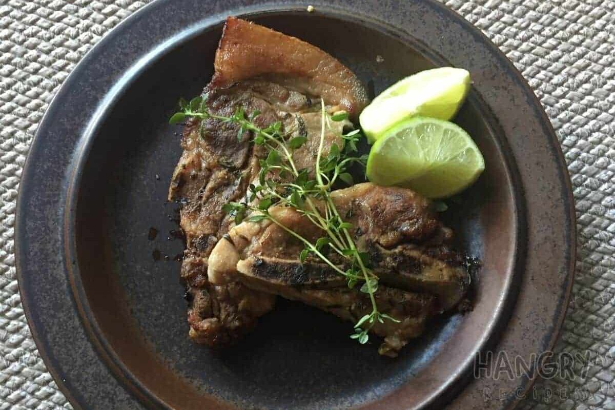Juicy Tender Pork chops seared and baked in oven with Lemons and Thyme